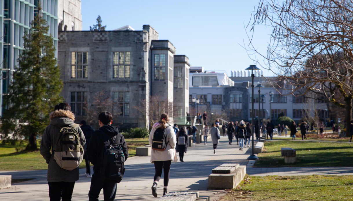 People waling in a larger educational campus