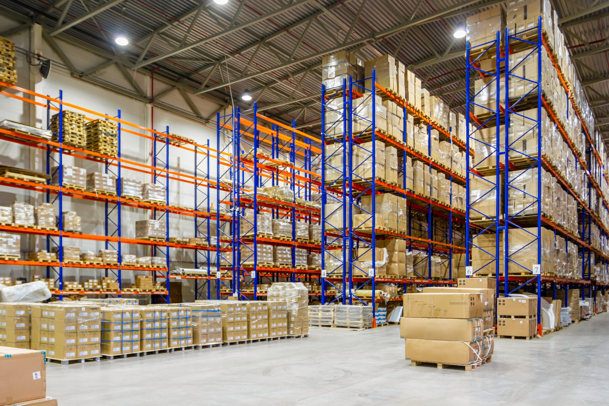 Large warehouse with tall shelves and pallets